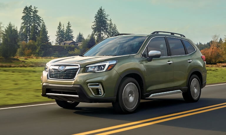 2020 Subaru Forester in green driving on countryside road