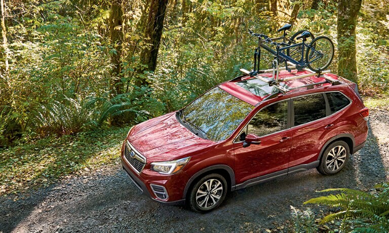 2020 Subaru Forester in green driving off road throughout forest
