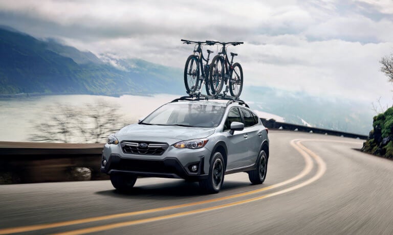 2021 Subaru Crosstrek driving next to a lake