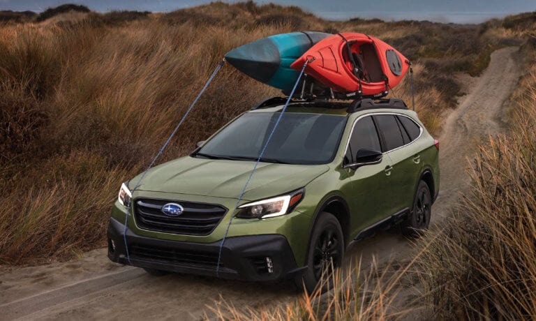 2022 Subaru Outback on a dirt road with kayaks