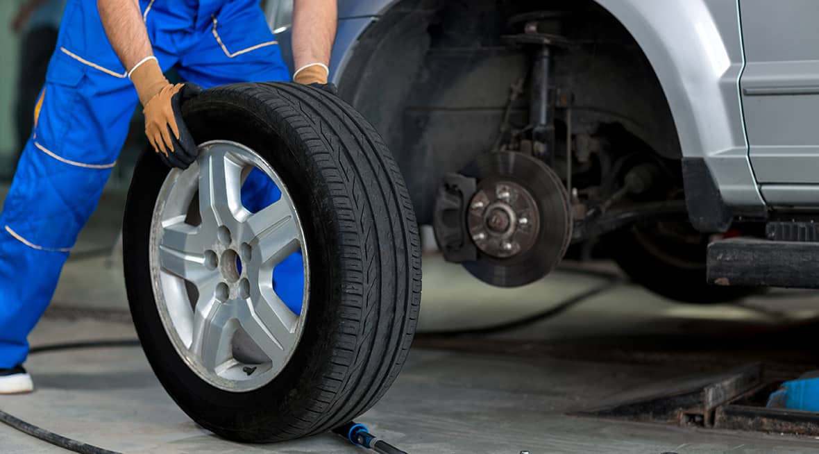 A service worker changing a tire.