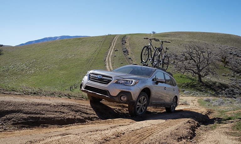 2019 Subaru Outback driving on dirt road