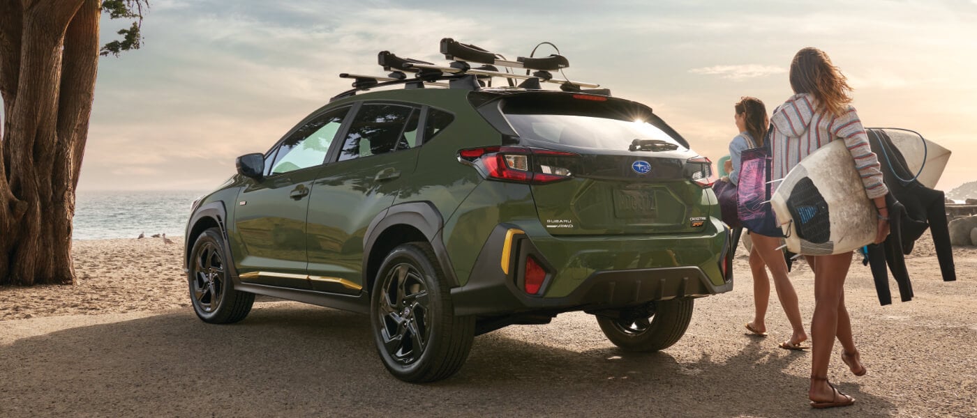2025 Subaru Crosstrek Exterior On Rocky Cliffs Parked Near Ocean With Surfers