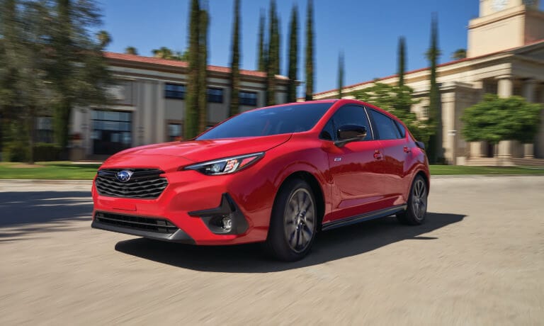 2026 Subaru Impreza Exterior Turning In Front Of Town Buildings