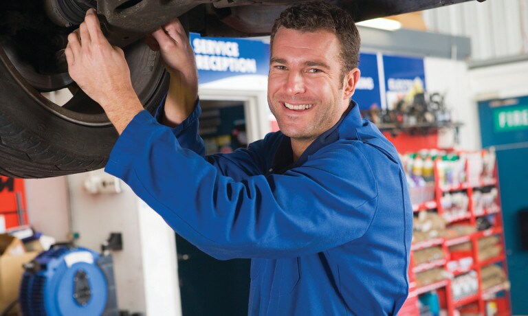 Mechanic inspecting vehicle