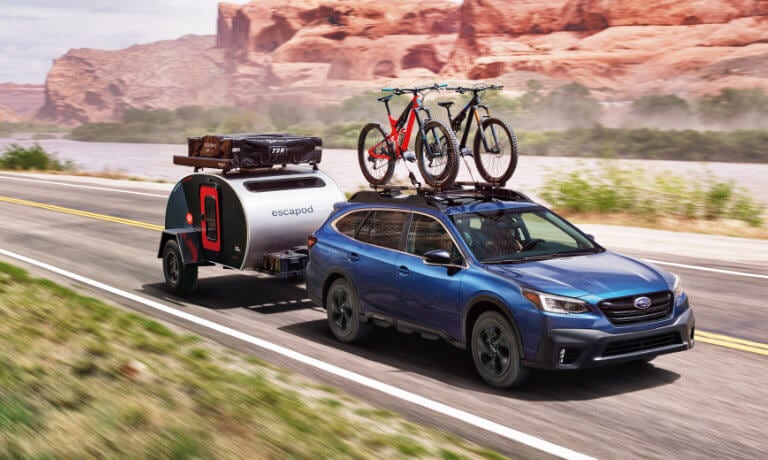 2021 Subaru Outback exterior towing camper and bikes