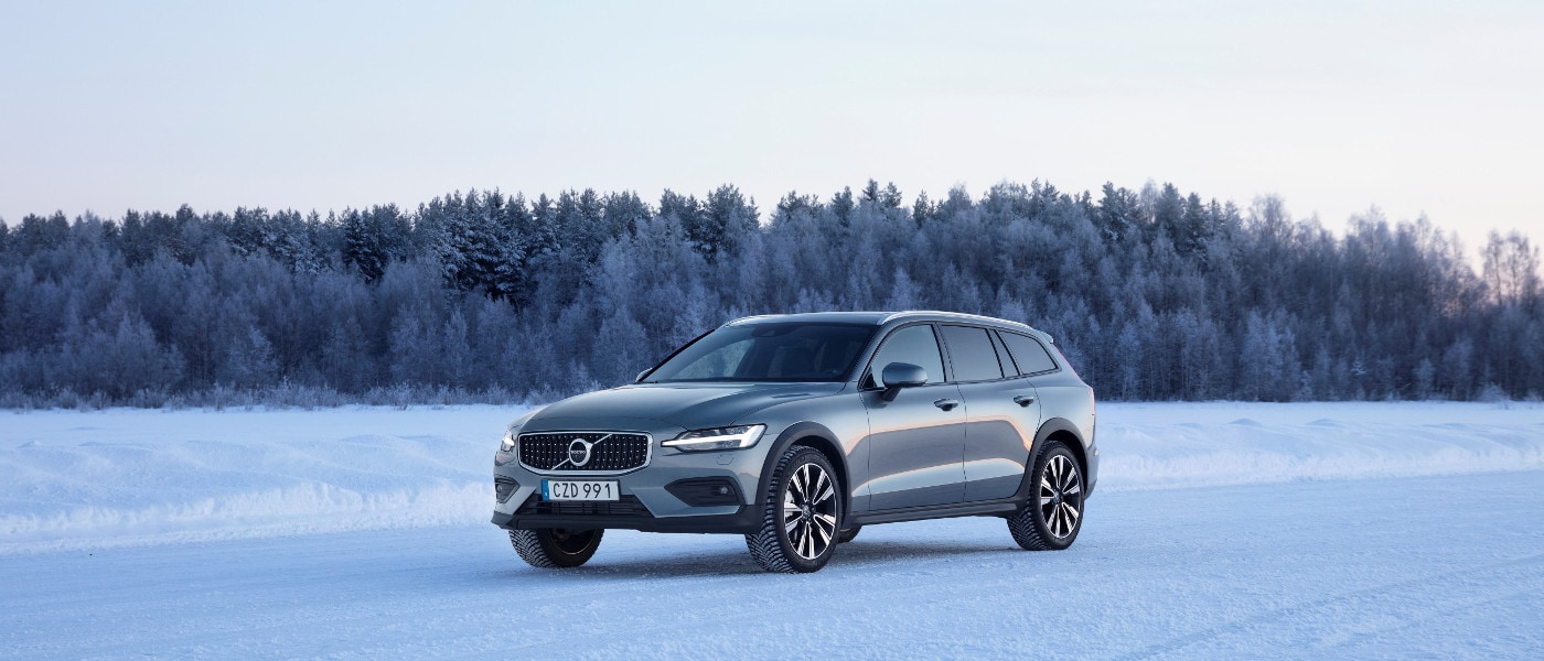 A Grey Volvo V60 Cross Country driving in snow
