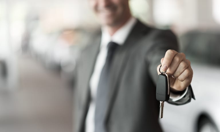 Salesperson handing keys