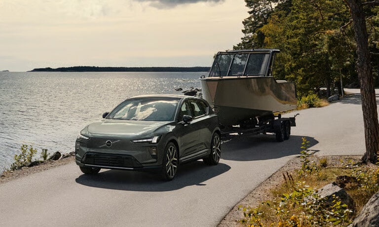 2027 Volvo EX60 towing a boat