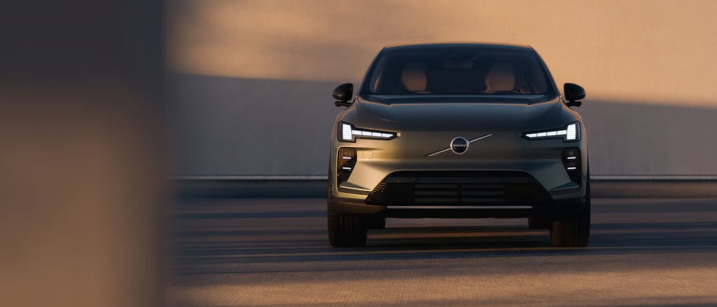 2027 Volvo EX60 facing head-on with headlights on