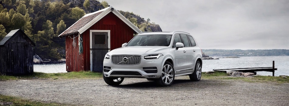 Volvo XC90 at a Lake A white Volvo XC90 parked at a lake in front of a red shed