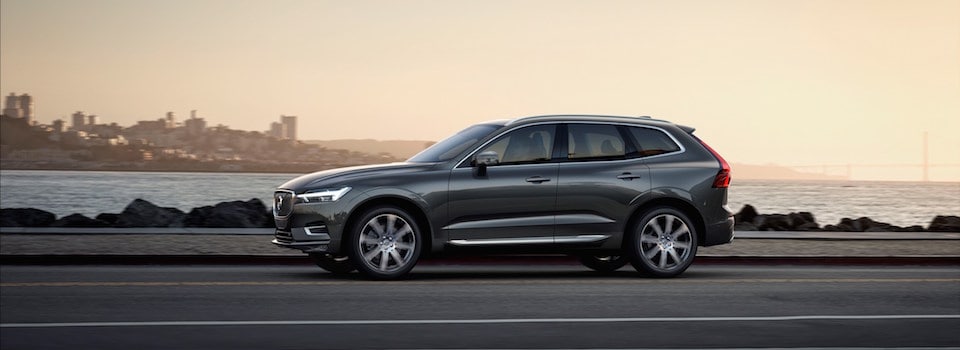 Volvo SC60 driving by the bay A Volvo XC60 driving down an open road by the sea