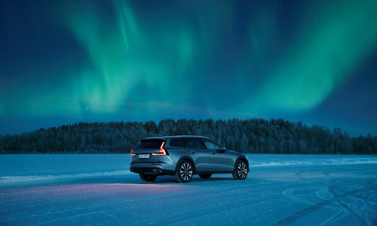 Grey Volvo V60 Cross Country near northern lights