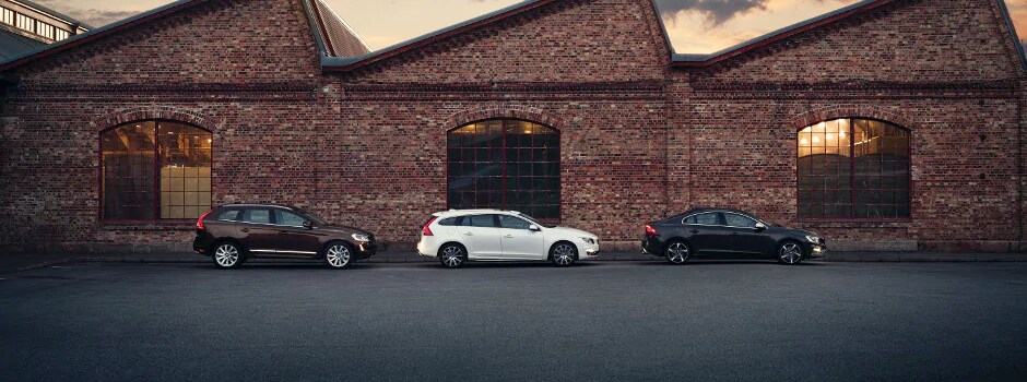 Volvo Model Research Three Volvo vehicles parked in front of a building