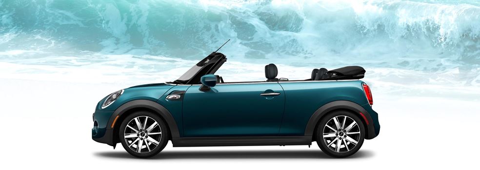 The MINI Cooper S Convertible Sidewalk
Edition in front of a large ocean wave.