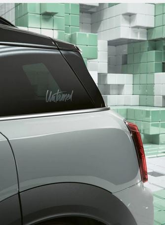 Closeup of the exclusive momentum grey metallic paint on a MINI Countryman Untamed Edition, in a CGI world made up of 3D, Tetris-like boxes.