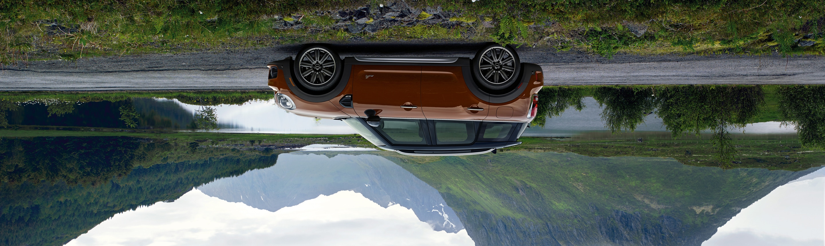 
Upside down
photo of Chestnut MINI Countryman in front of mountain landscape.
