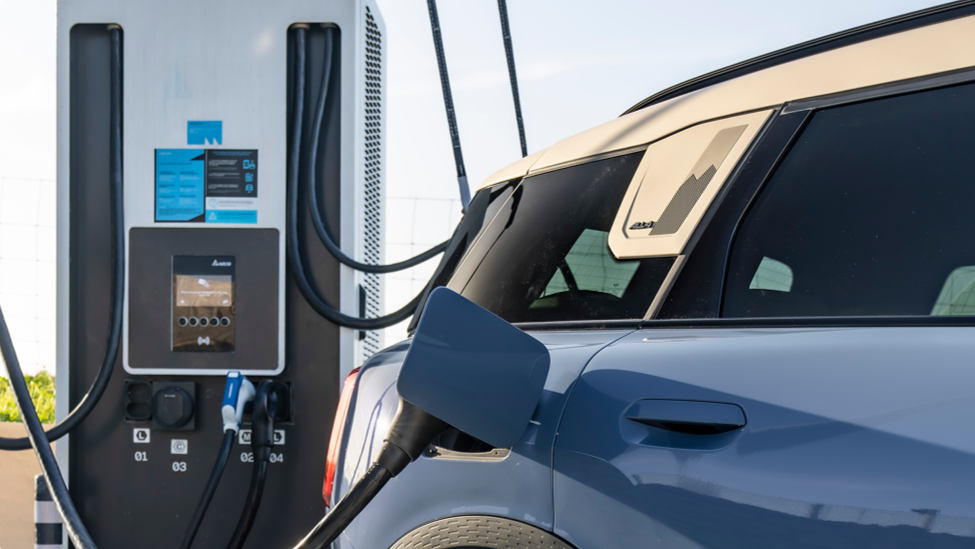 A MINI Countryman SE ALL4 charging at a charging station.