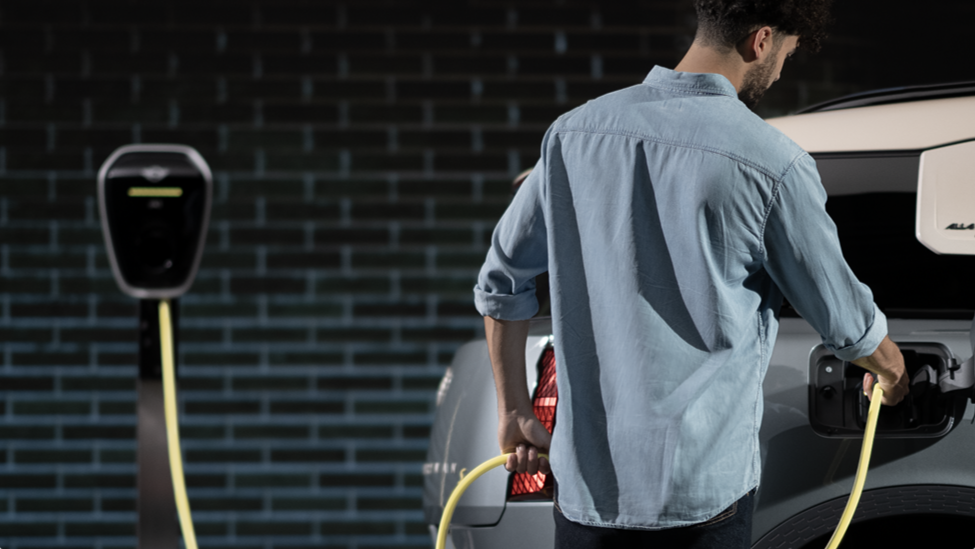 A man charges his MINI Countryman SE ALL4.