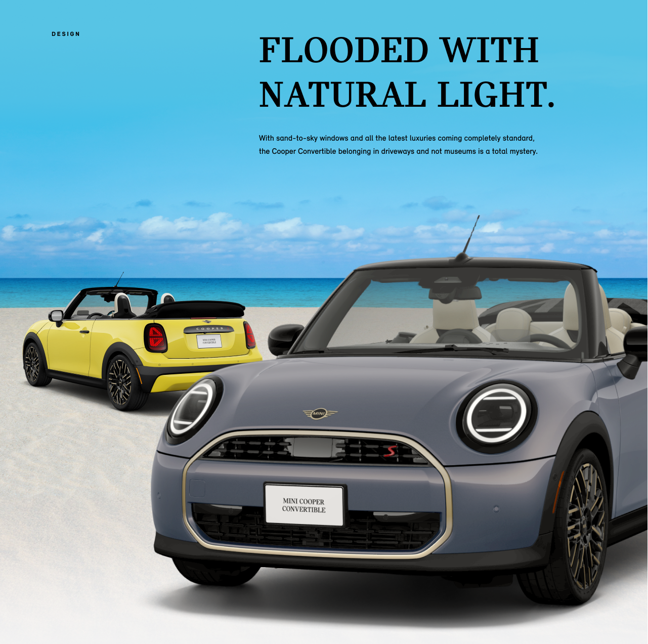 Rear side view of yellow MINI Cooper Convertible behind a front side view of gray MINI Cooper Convertible parked on the 
beach.