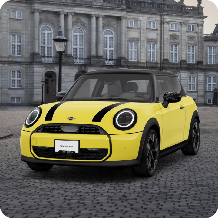 Angled view of MINI Cooper Oxford Editon parked in a cobblestone area. 
