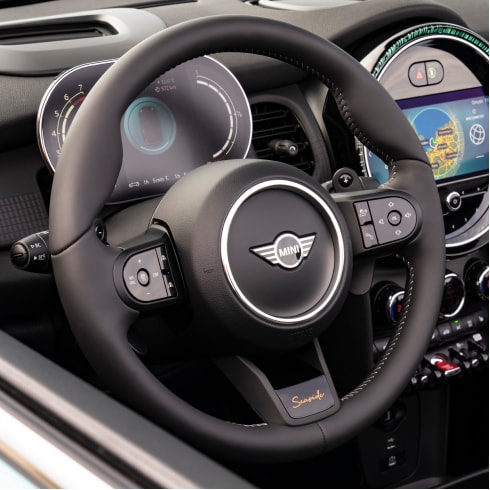 Closeup view of the heated multi-function steering wheel in a MINI Cooper S Convertible Seaside Edition.