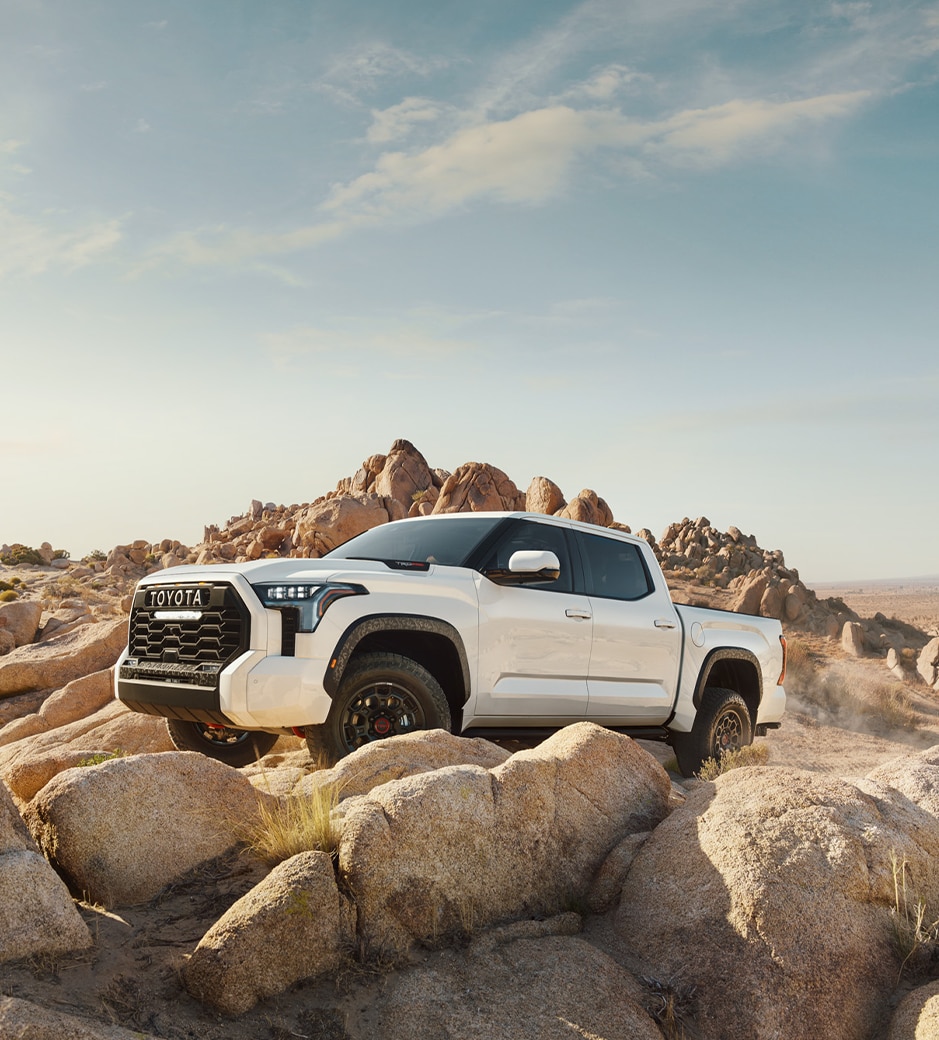 The New 2023 Toyota Tundra at Mechanicsville Toyota in Mechanicsville, VA | White 2023 Toyota Tundra parked on an incline hill with big rocks around it