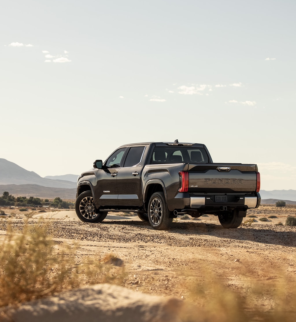 The New 2023 Toyota Tundra at Mechanicsville Toyota in Mechanicsville, VA | Rear view of black Toyota Tundra parked on outside with mountains in the background