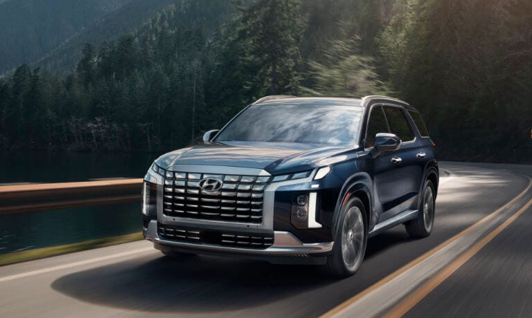 2023 Hyundai Palisade exterior driving on forest highway