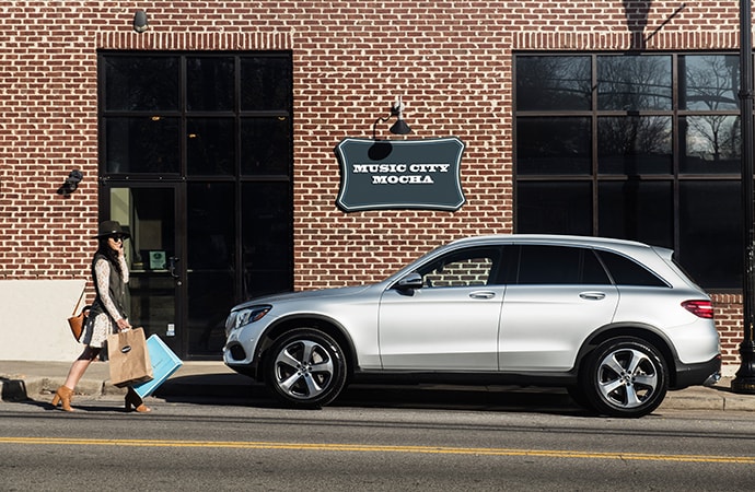 Silver Mercedes-Benz GLC parked outside a store
