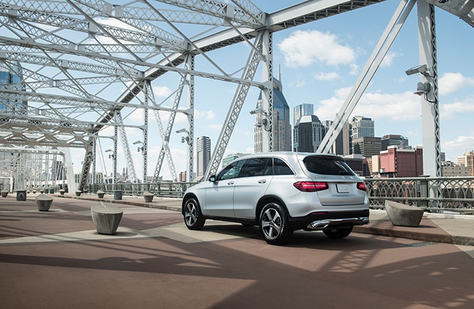 Silver Mercedes-Benz GLC driving over a bridge