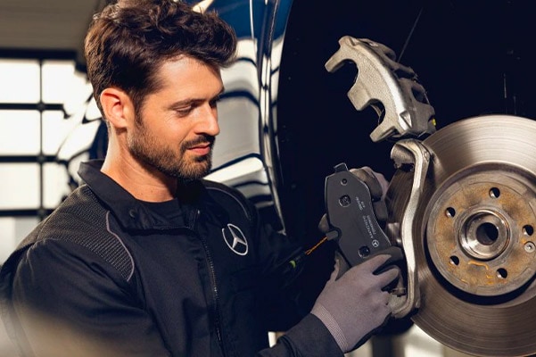Mercedes benz technician installing new brakes on a mercedes benz vehicle