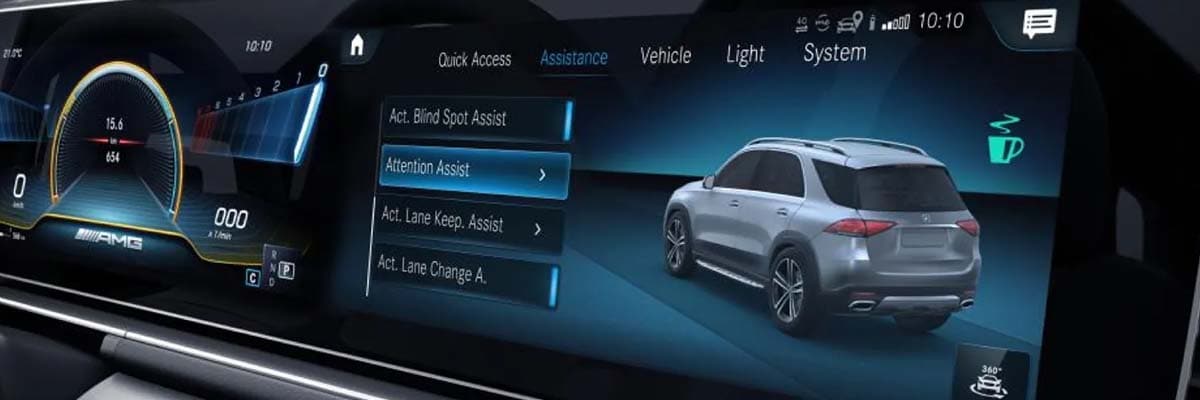 A widescreen digital dashboard with graphics of the speedometer and vehicle, and Attention Assist highlighted.