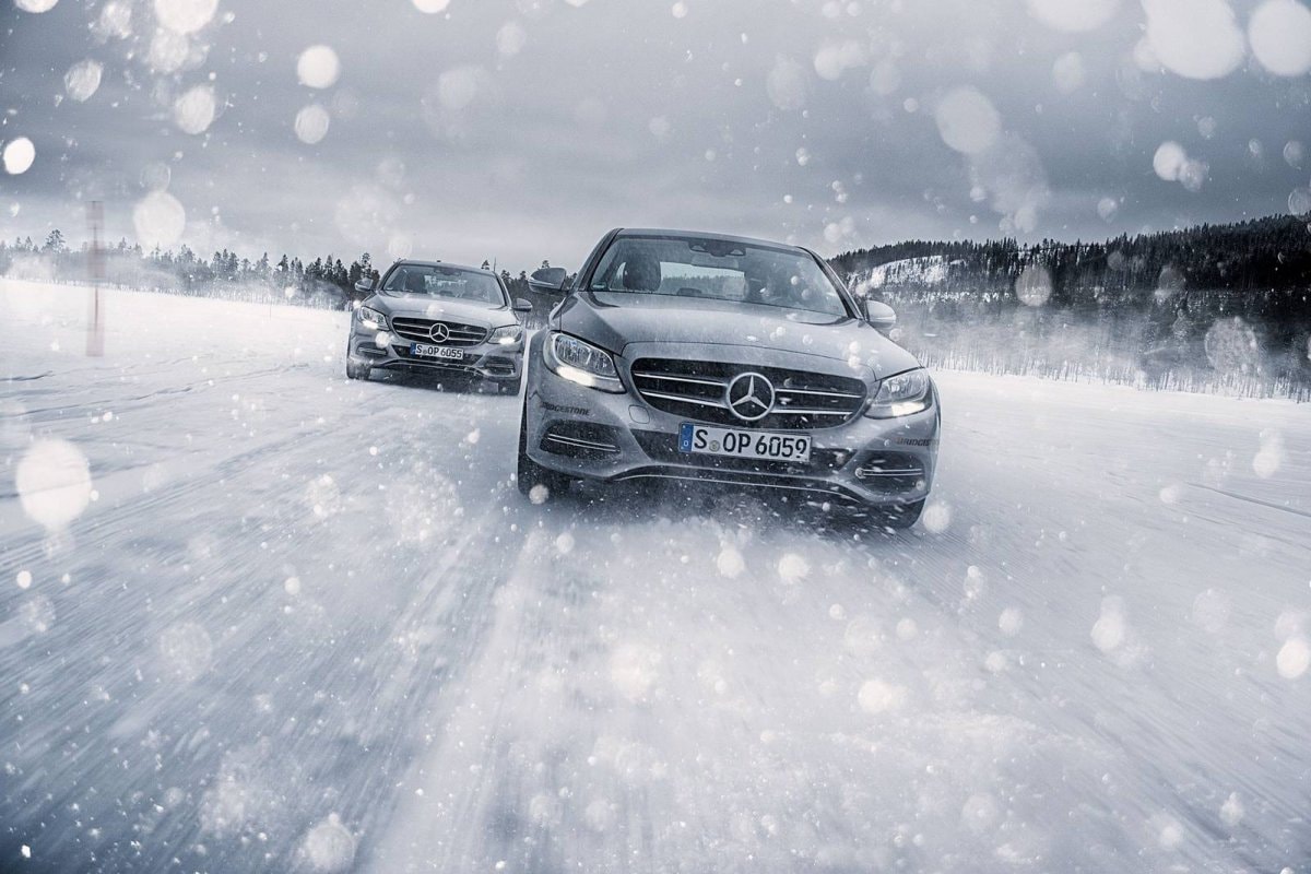 two Mercedes-Benz models driving in snow