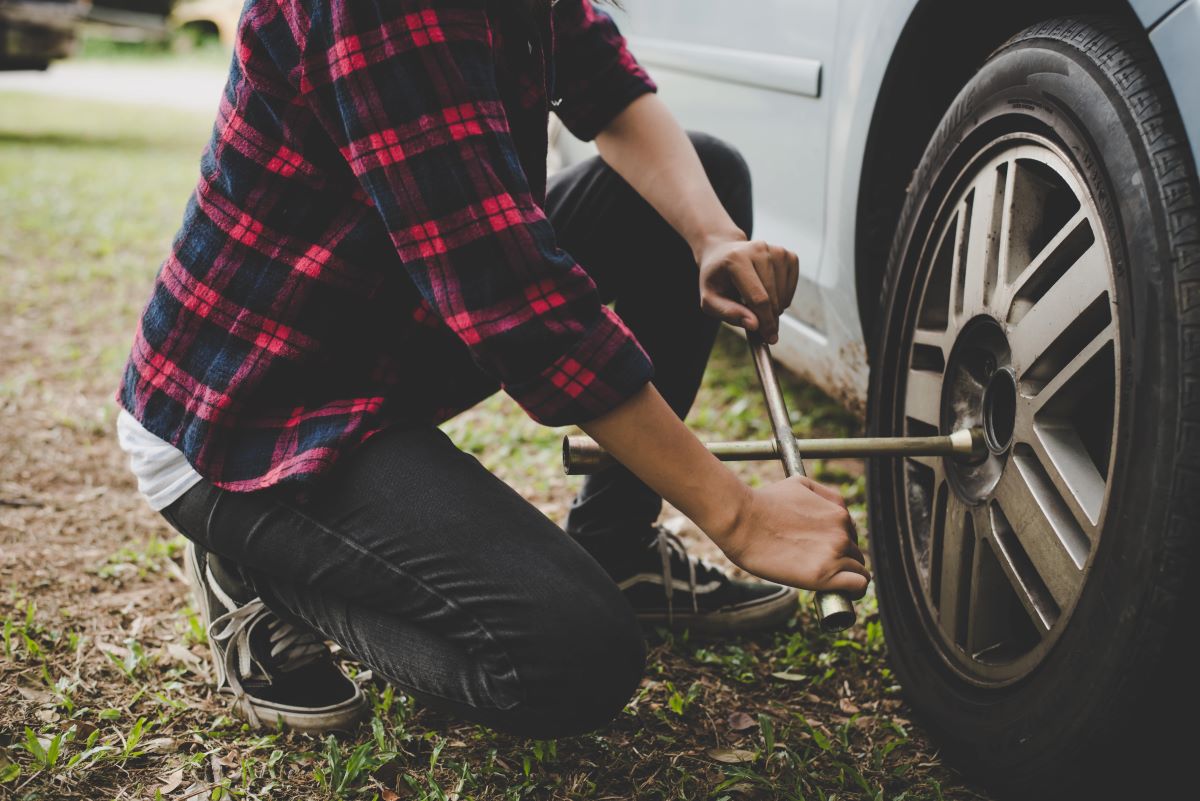 Person changing a flat tire