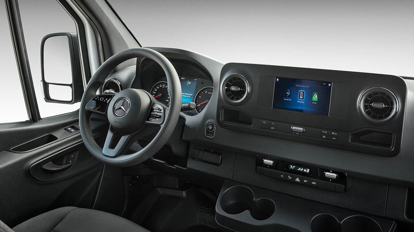 Learn about the specs, configurations, and color options of the Mercedes-Benz Sprinter Cargo Van Mercedes-Benz Sprinter Cargo Van interior shot showing the steering wheel and dashboard console