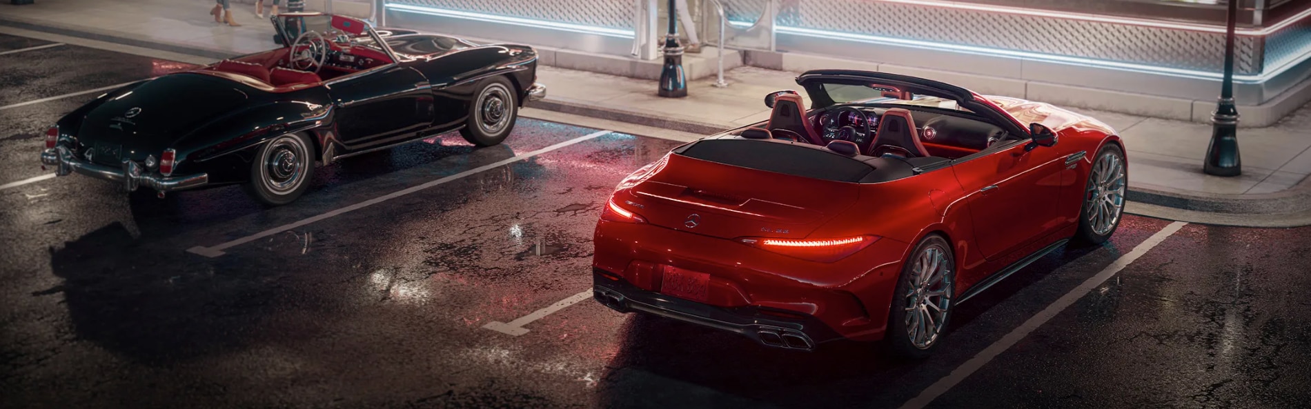 A modern Mercedes-Benz convertible parked next to a classic Mercedes-Benz model.