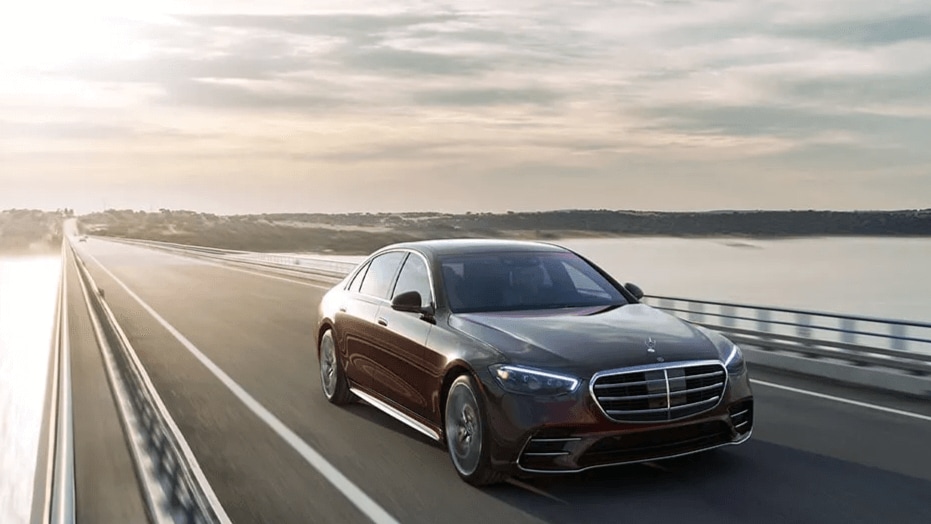 A Mercedes-Benz S-Class driving down across a bridge