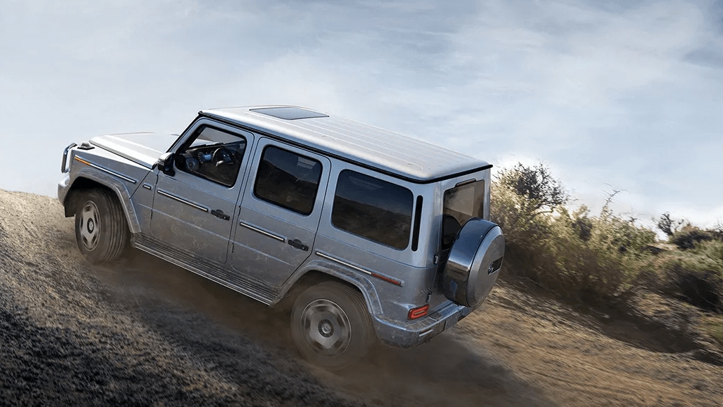 Learn about the off-road capabilities of the Mercedes-Benz G-Class SUV Rendered image of a Mercedes-Benz G-Class SUV traversing a dirt incline