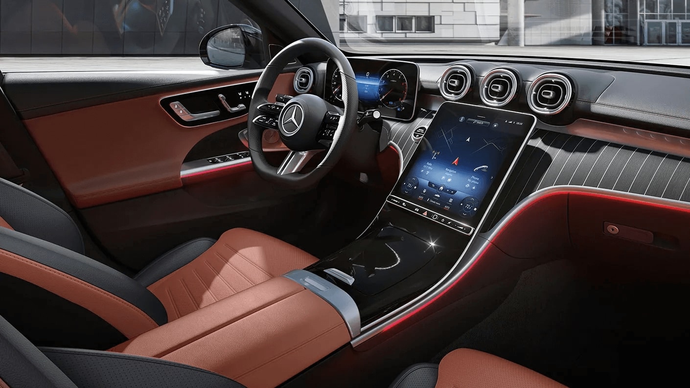 Interior shot of the Mercedes-Benz C-Class interior showing the steering wheel and dashboard controls/interface