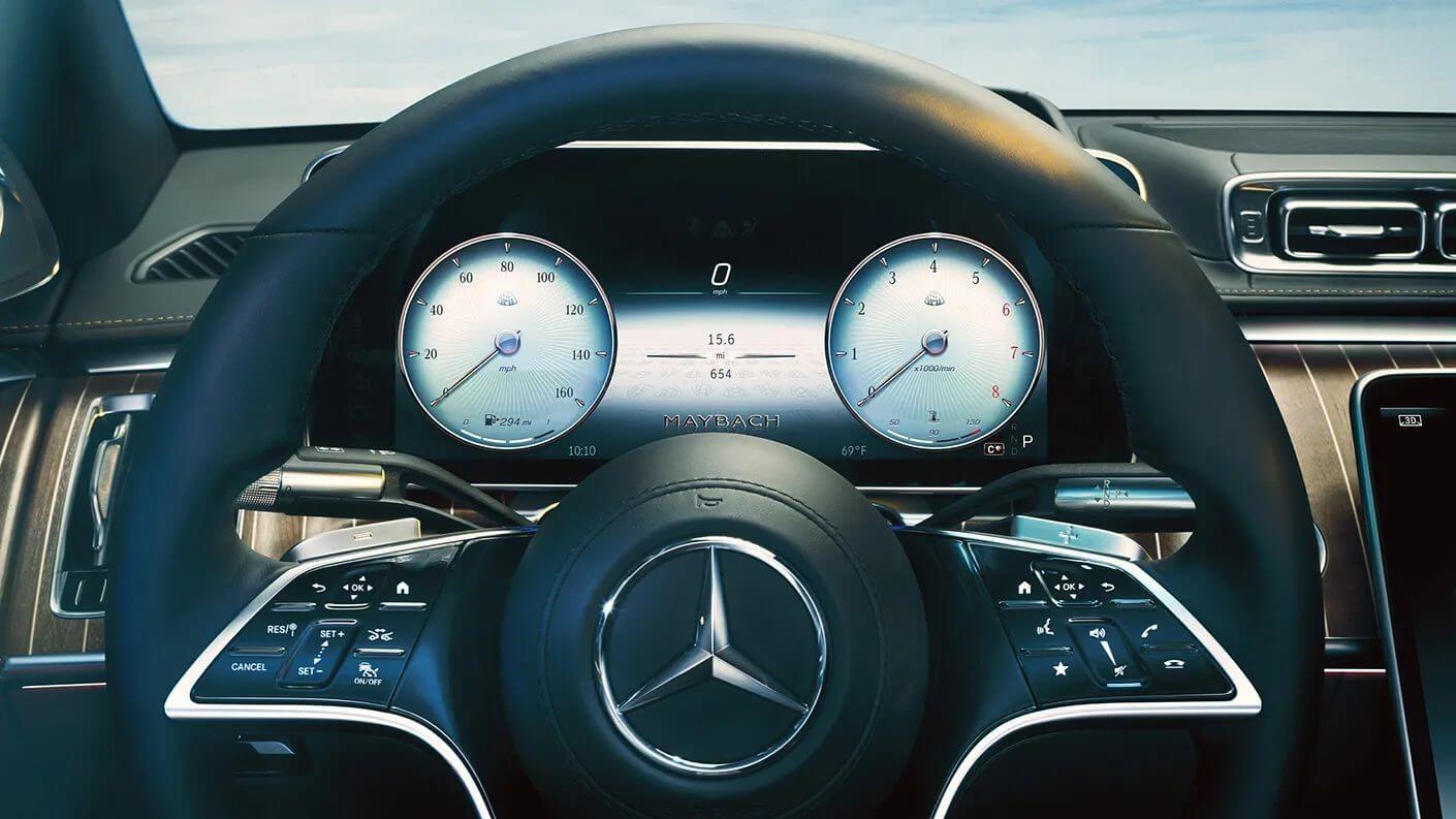 Interior render of Mercedes-Maybach S-Class showing the steering wheel and digital information cluster panel