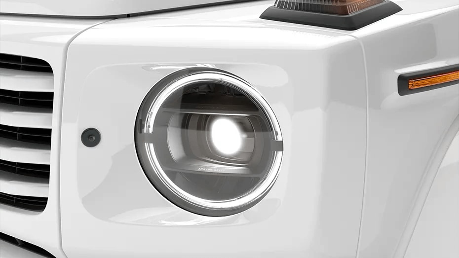 Learn about the safety features of the Mercedes-Benz G-Class Closeup shot of the front left headlamp on the Mercedes-Benz G-Class SUV