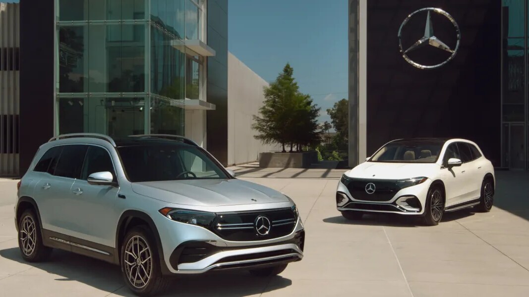 Outdoor shot of two Mercedes-Benz SUVs parked outside two buildings