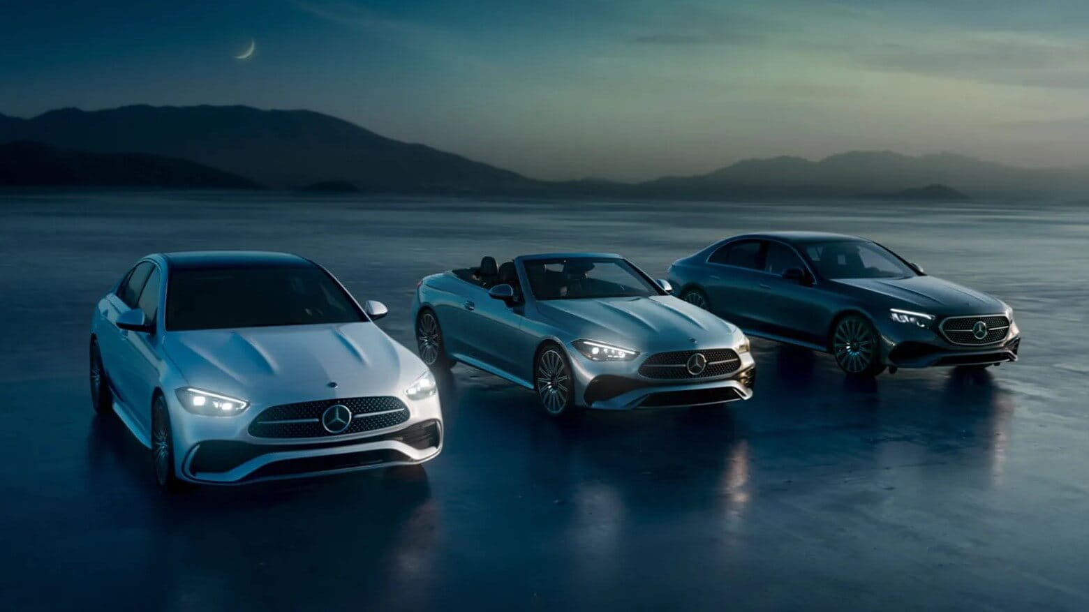 A lineup of three Mercedes-Benz vehicles parked outside in a sunrise setting