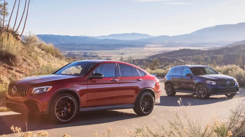 A pair of Mercedes-Benz vehicles parked in the sun