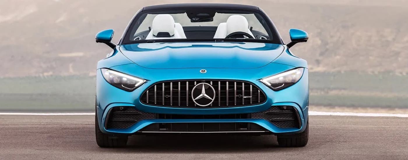 A blue front-facing 2024 Mercedes-Benz SL Roadster parked.