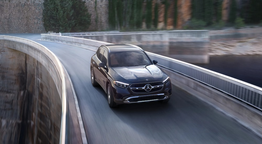 Overhead view of a silver 2025 Mercedes-Benz GLC 300 driving over a bridge.