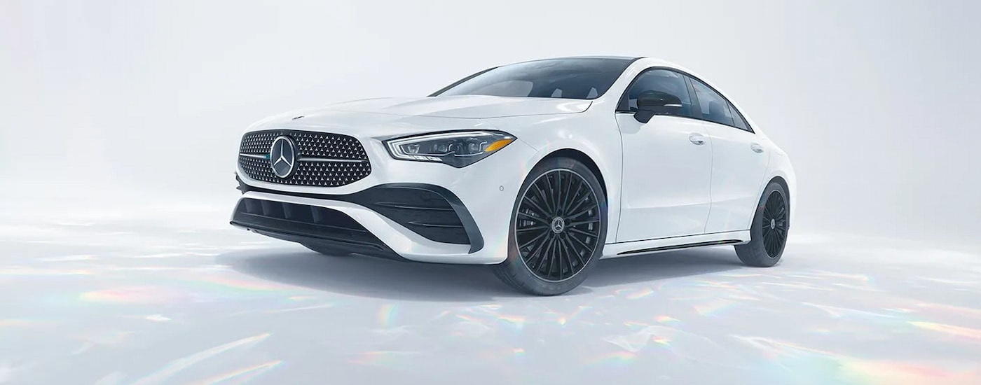 A white 2024 Mercedes-Benz CLA coupe parked in a white room.