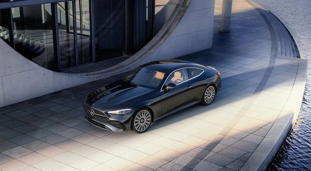 High angle view of a black 2024 Mercedes-Benz CLE 300 4MATIC parked in a city and angled left.