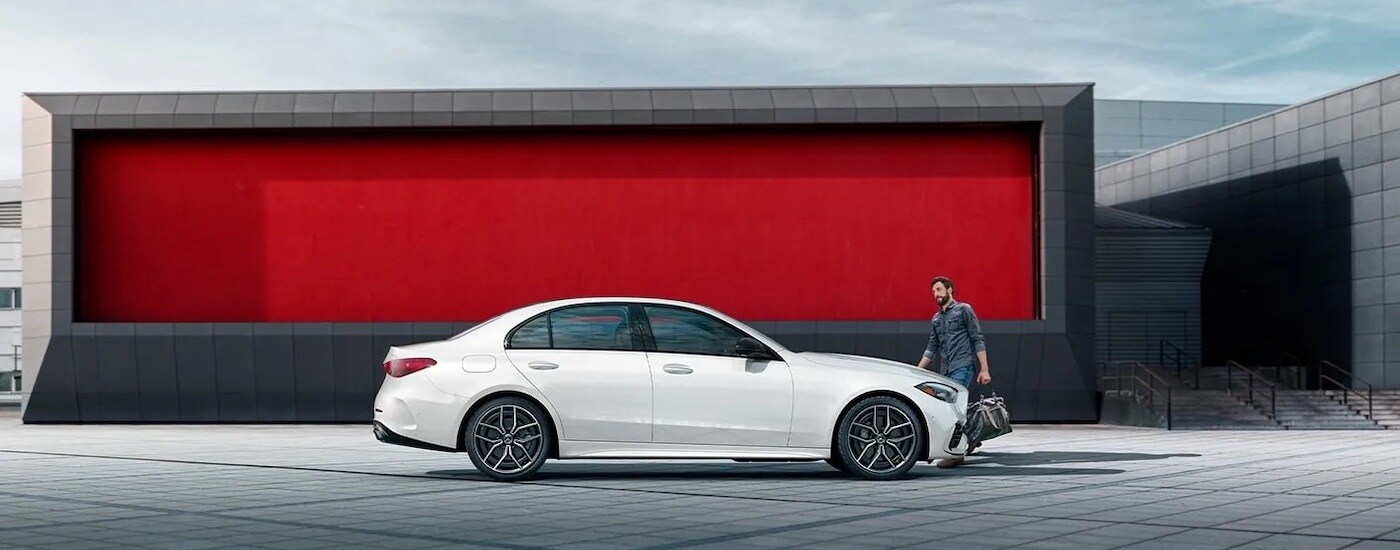 A white 2024 Mercedes-Benz C-Class sedan is shown from the side.